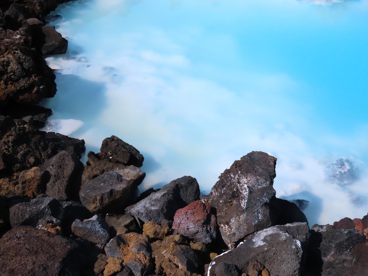 Turquoise geothermal water and dark volcanic rocks at the Blue Lagoon, Iceland