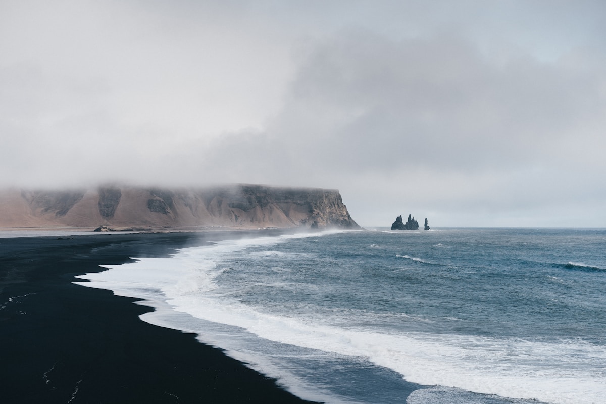 Reynisfjara black sand beach with Reynisdrangar sea stacks rising from the Atlantic, south Iceland