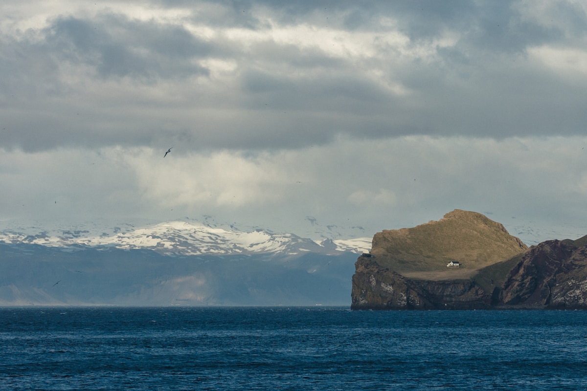 Landscape view of islands and snow-covered mountain, Vestmannaeyjar, Iceland