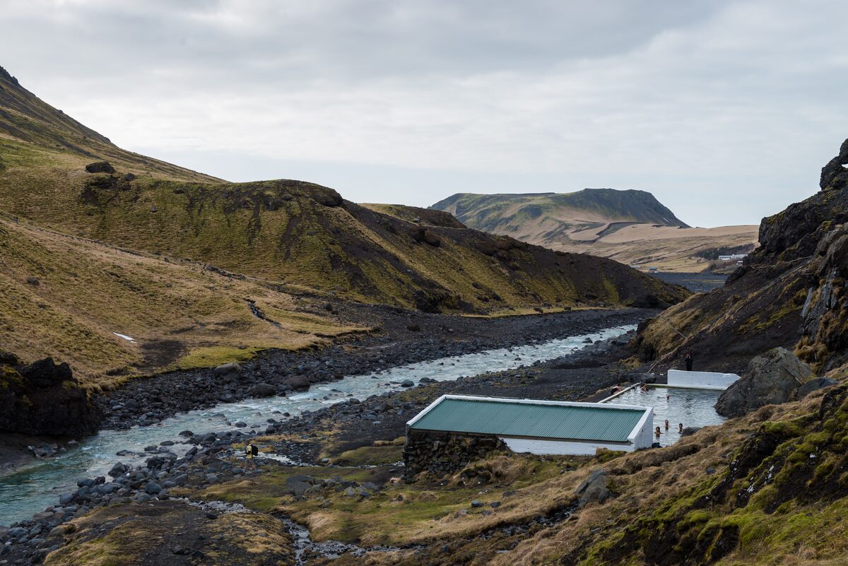 Natural hot spring pool in a highland river valley, Iceland — similar to the Secret Lagoon at Flúðir