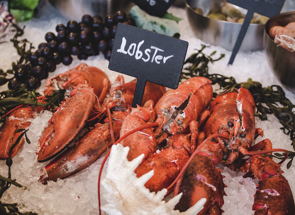 Fresh whole lobsters displayed on ice at a seafood market