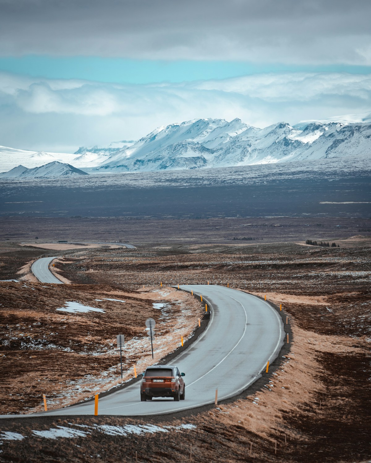 Car driving on a road in front of a mountain, Iceland
