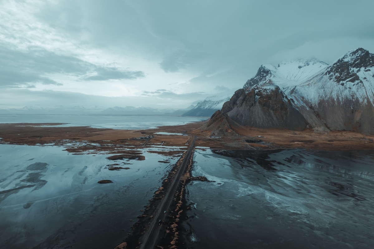 Aerial view of Iceland river and mountain landscape — the terrain that makes Iceland's weather and road apps essential for safe travel