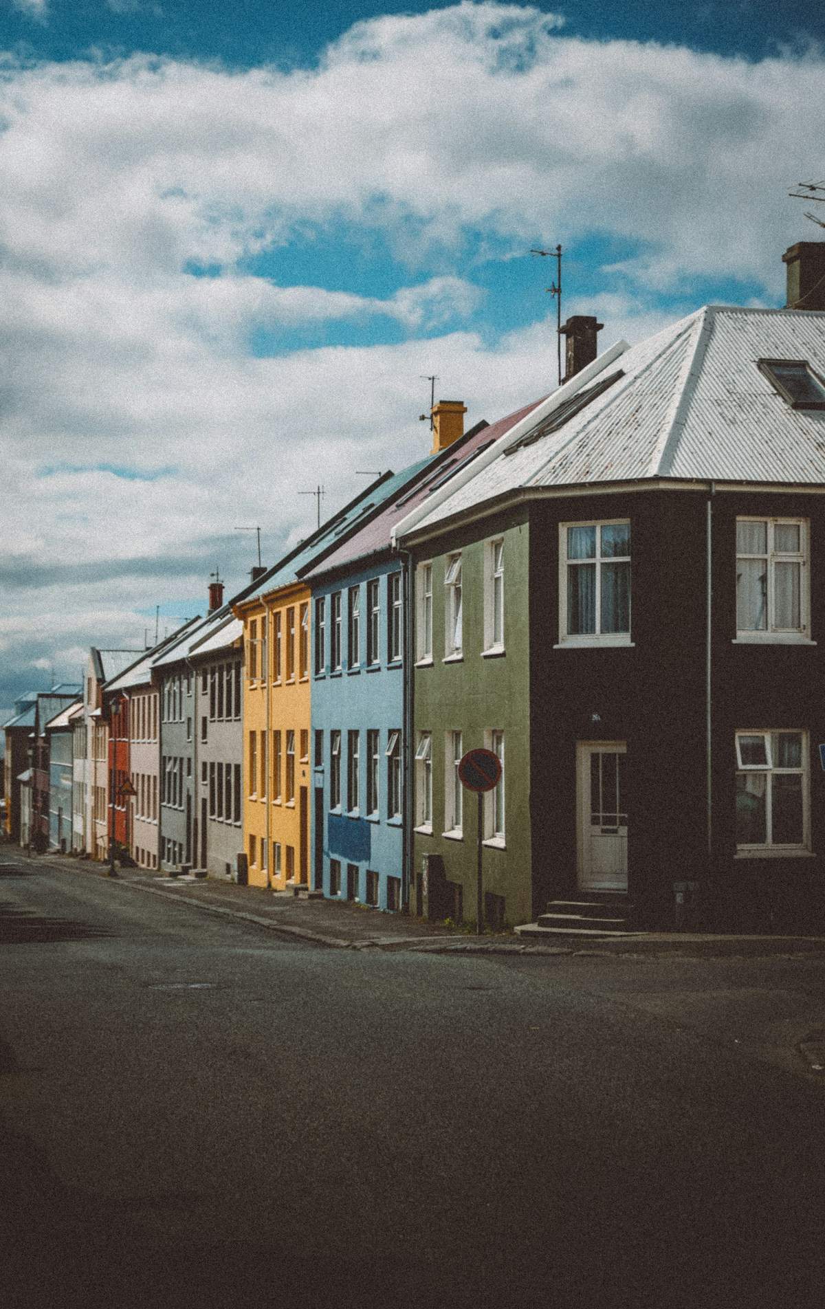 Row of houses and parked cars on a street in Reykjavik, Iceland