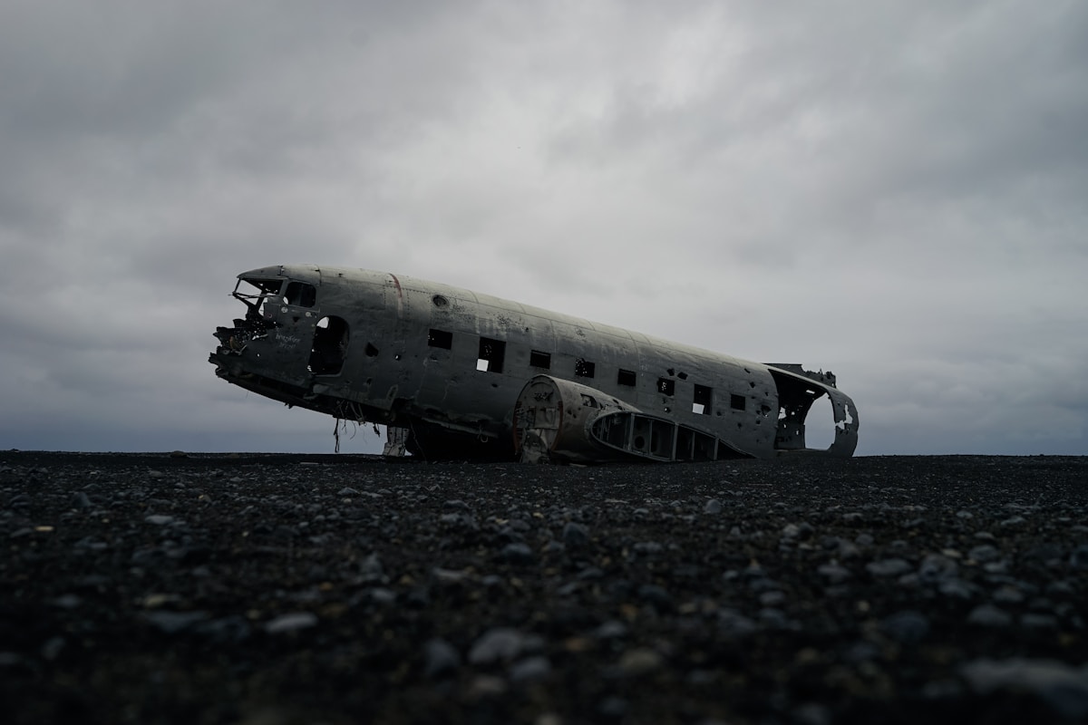 White aeroplane resting on grey volcanic sand at Sólheimasandur plane wreck, Iceland