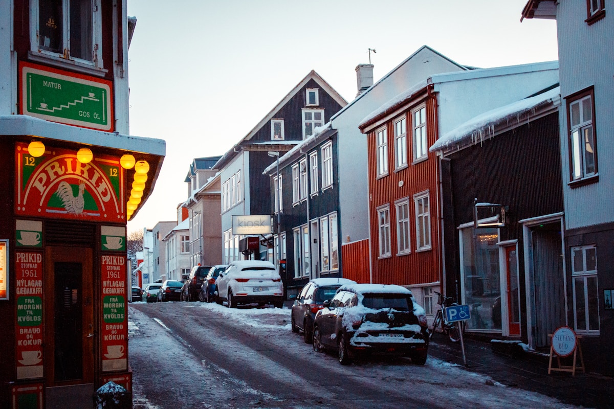 Cars parked in front of a brown building on a quiet Reykjavik street, Iceland