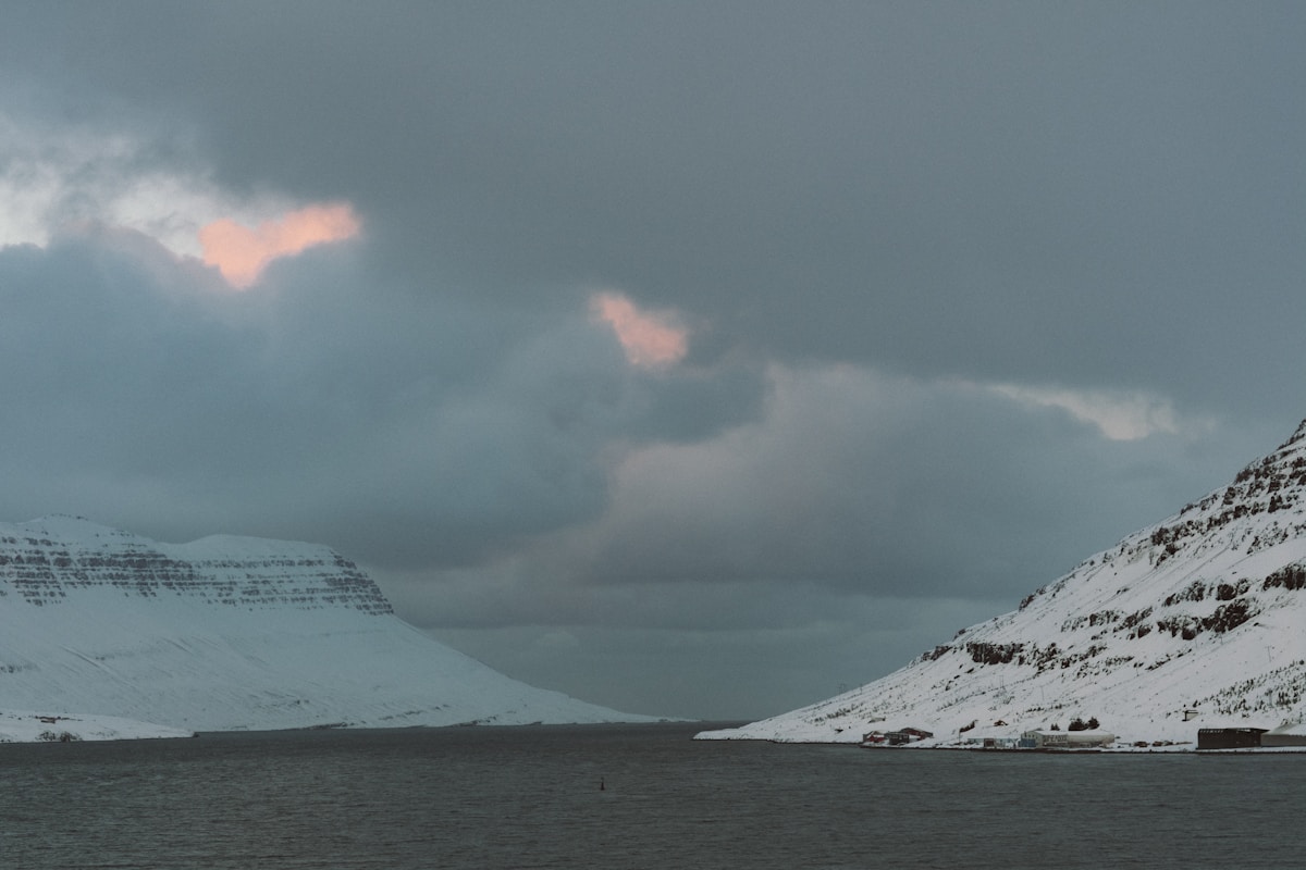 Large fjord surrounded by snow-covered mountains, Seyðisfjörður, east Iceland