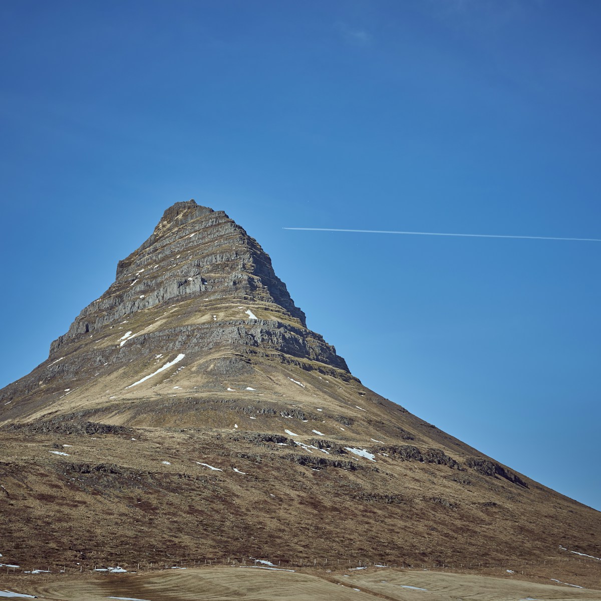 Grey Kirkjufell mountain rising above the Snæfellsnes peninsula, Iceland