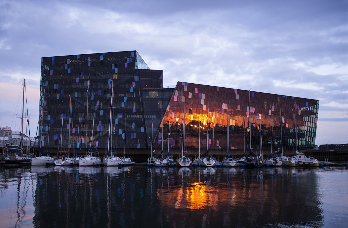 The colorful Harpa Concert Hall reflecting in Reykjavik harbour