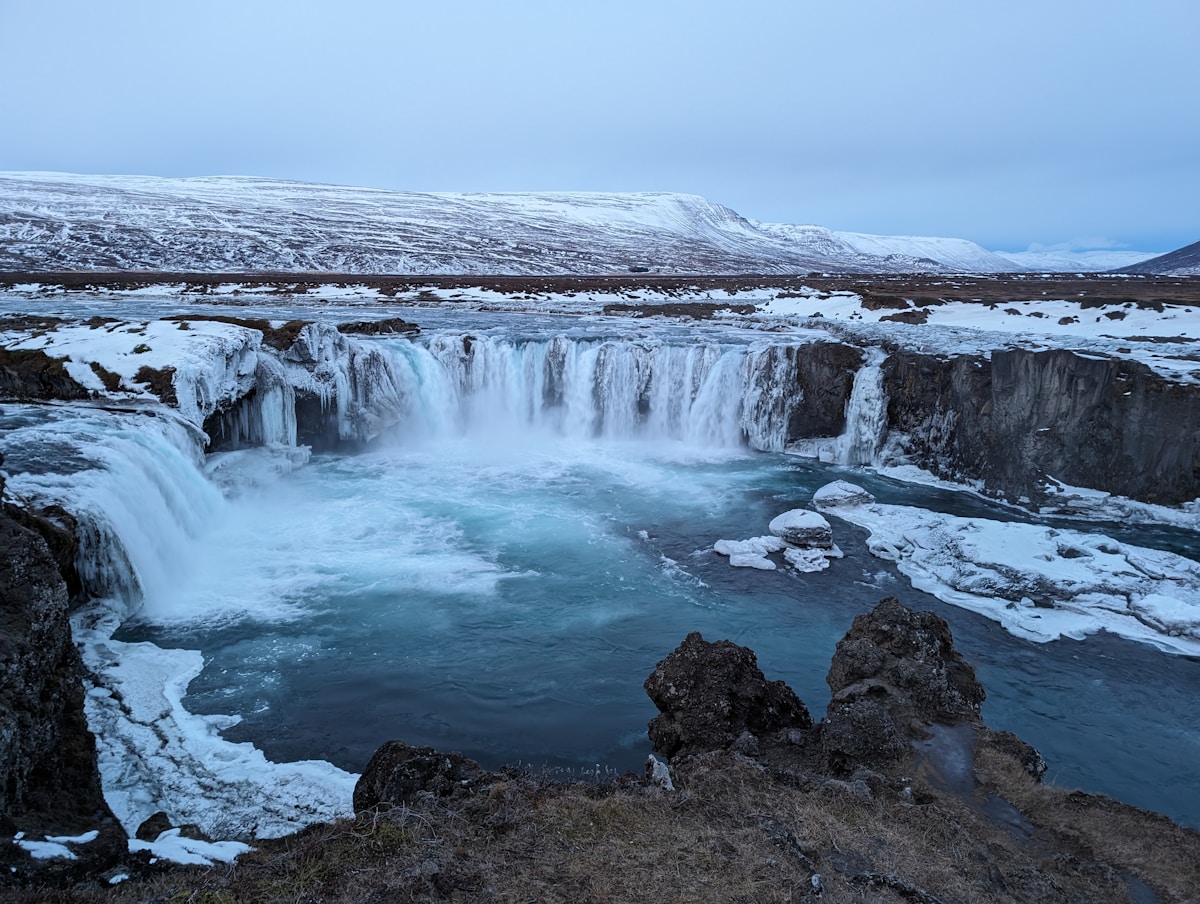 Hikers crossing the Fimmvörðuháls mountain pass with glaciers visible in Iceland