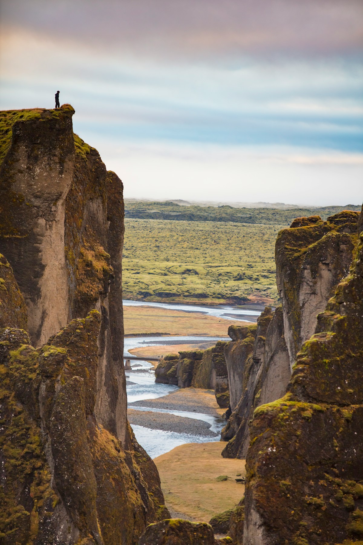 Tent pitched at an Icelandic campsite with mountains and a river in the background
