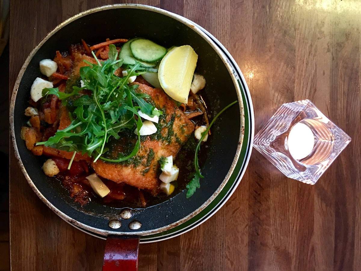 Salmon fillet with vegetables in a pan at a Reykjavik restaurant, Iceland