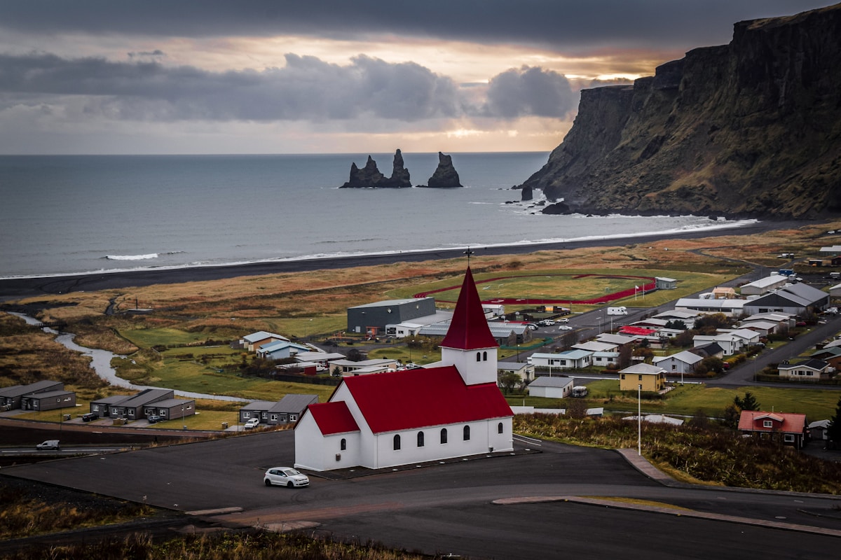 White and brown building near the waterfront in Vík í Mýrdal, south Iceland