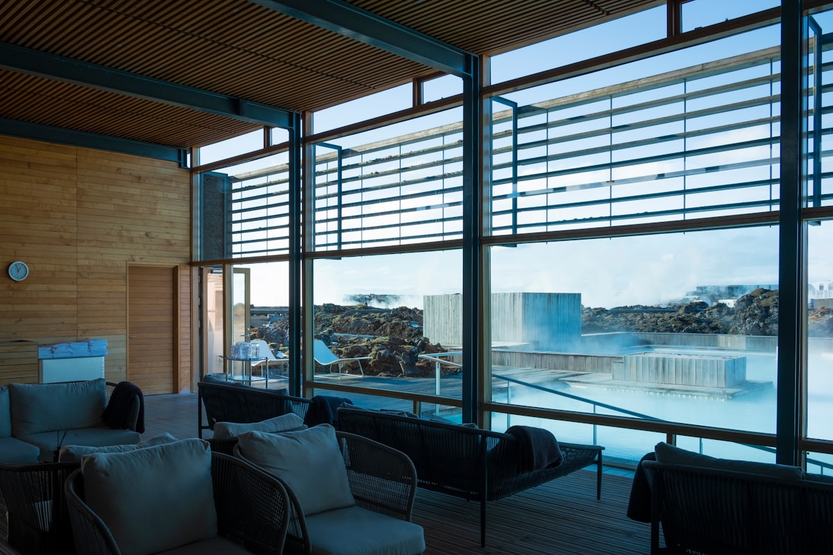 Luxury hotel lounge with floor-to-ceiling windows overlooking the Blue Lagoon geothermal pool at Silica Hotel, Iceland