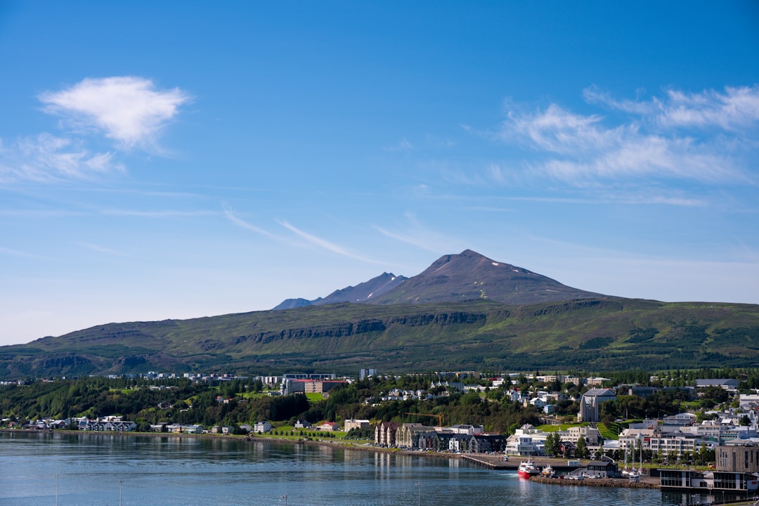 Aerial view of Akureyri town with fjord and mountains in summer