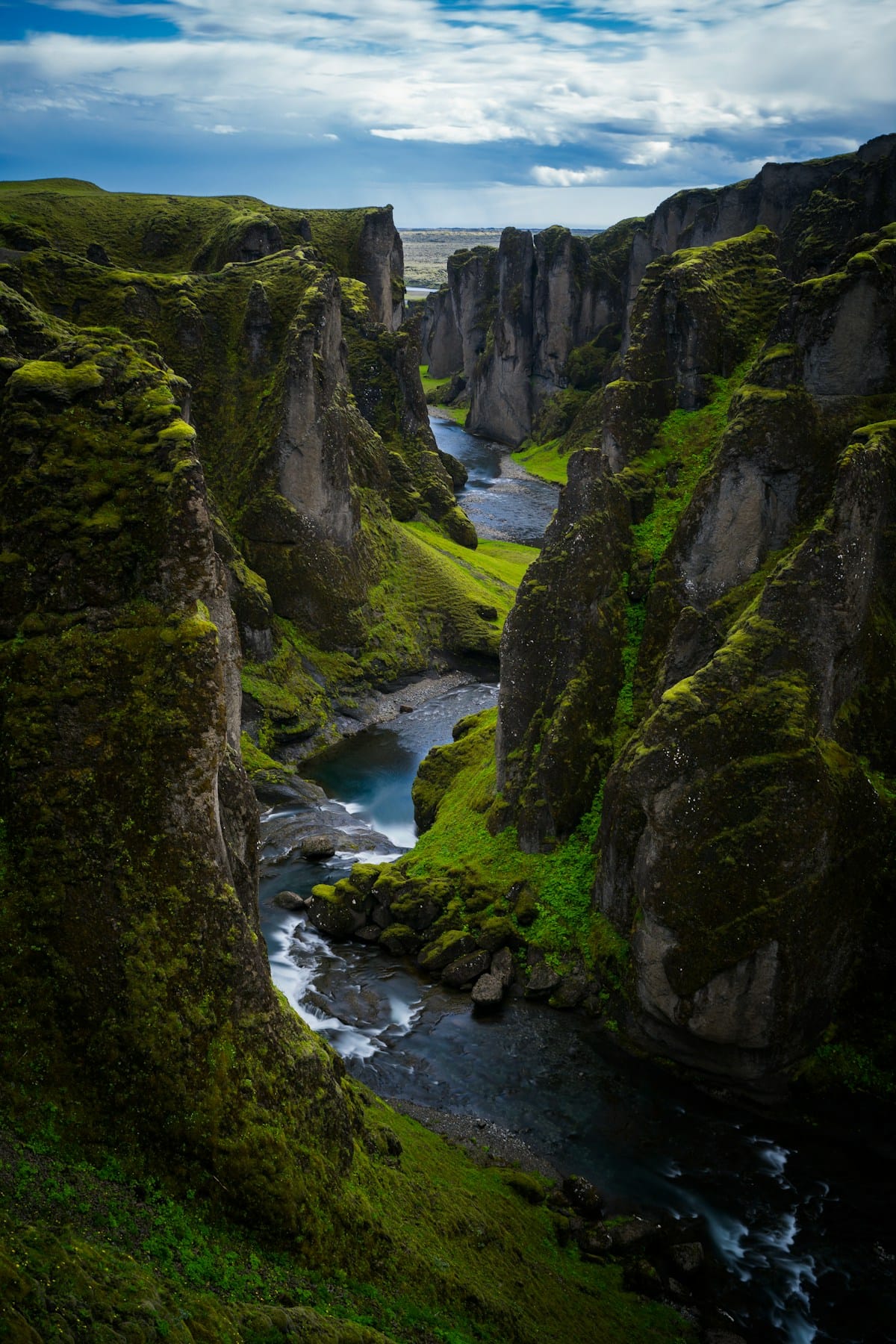 Dramatic river canyon with moss-covered cliffs at Fjaðrárgljúfur, south Iceland
