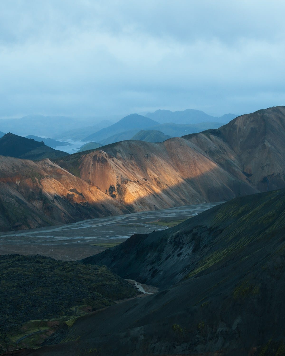 Aerial view of ochre and rust-coloured rhyolite mountains at Landmannalaugar, Iceland