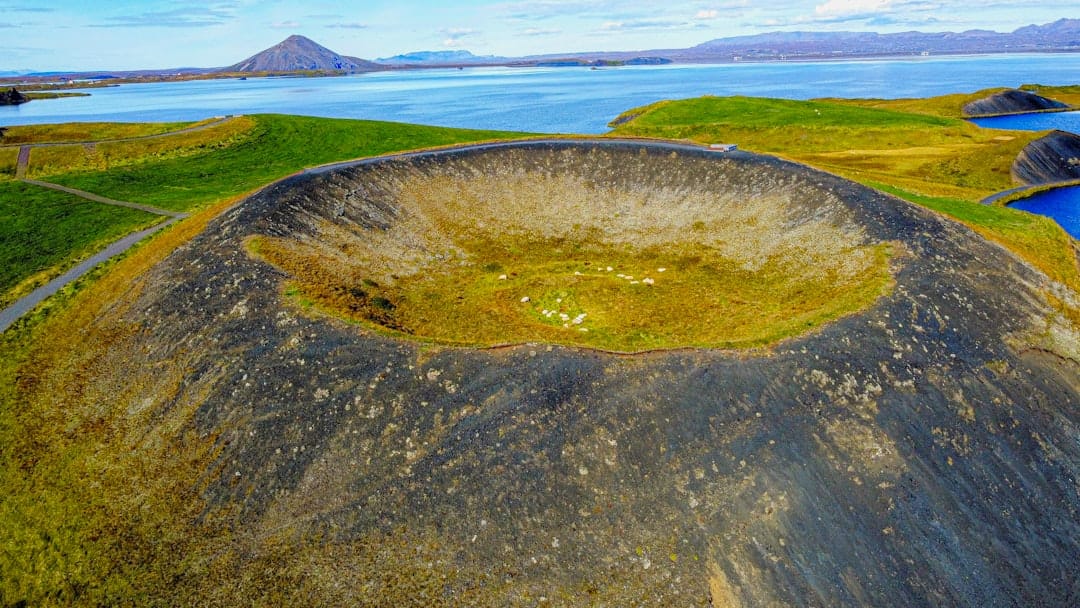 Aerial view of Mývatn pseudo-crater with the lake and volcanic mountains behind