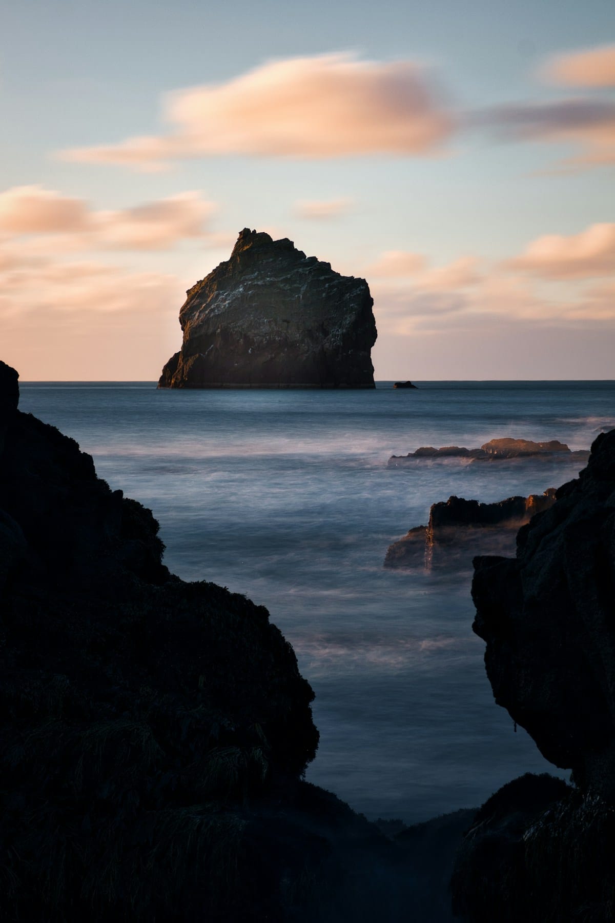 Dramatic volcanic rock stack rising from the ocean at sunset, Reykjanes peninsula Iceland